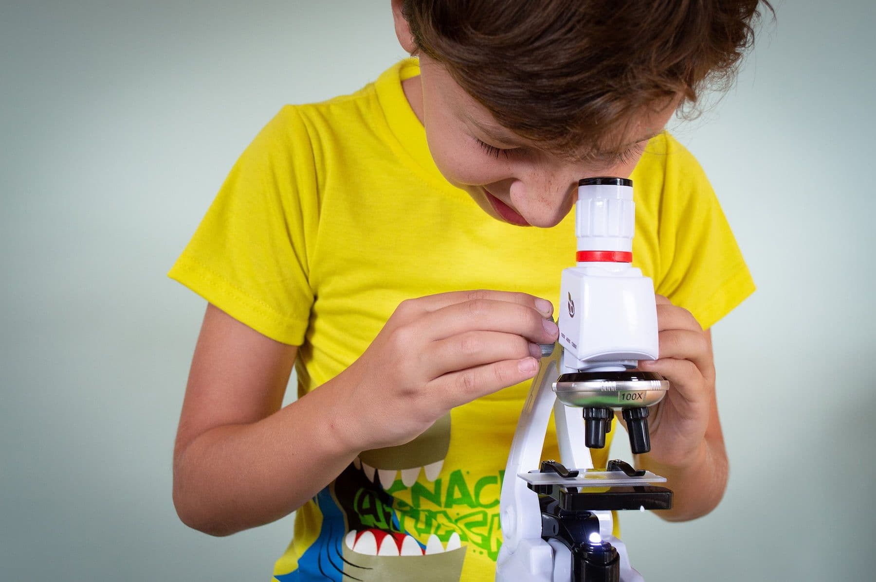 Boy looking through microscope